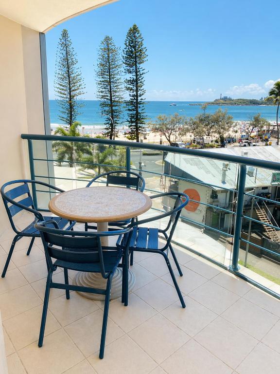 a table and chairs on a balcony with a view of the beach at Landmark Resort Mooloolaba 4th Floor Apartment with a View in Mooloolaba