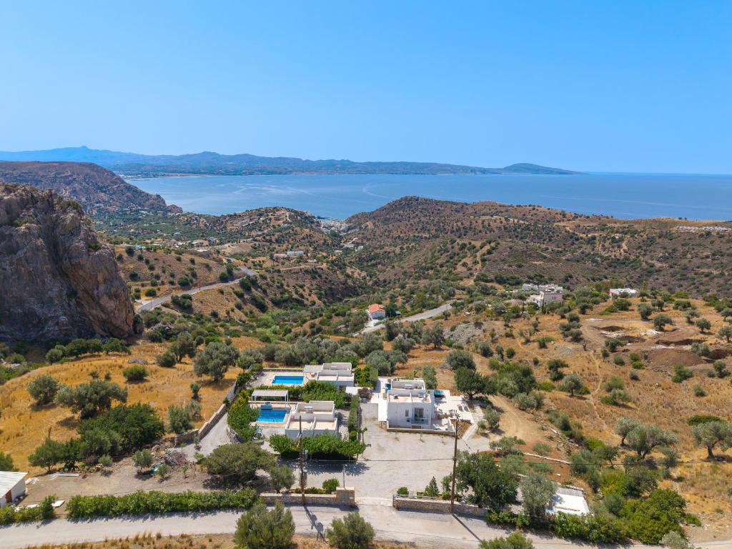 an aerial view of a villa with a view of the water at Evgoro Luxury Suites in Agia Galini