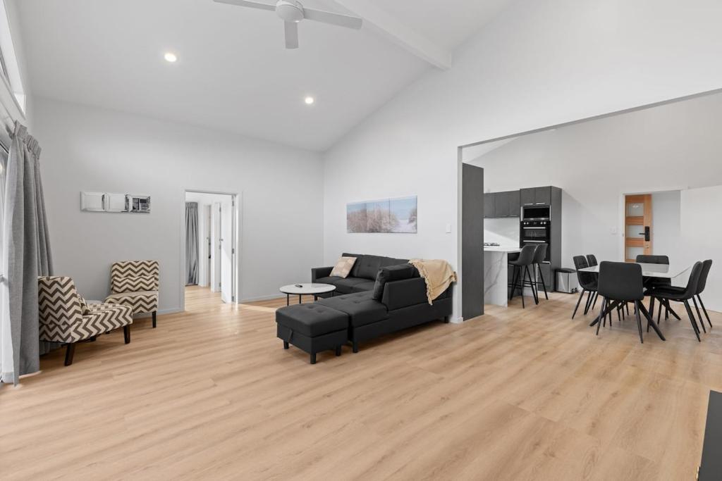 a living room with a couch and a table at Brookside Residence in Rolleston