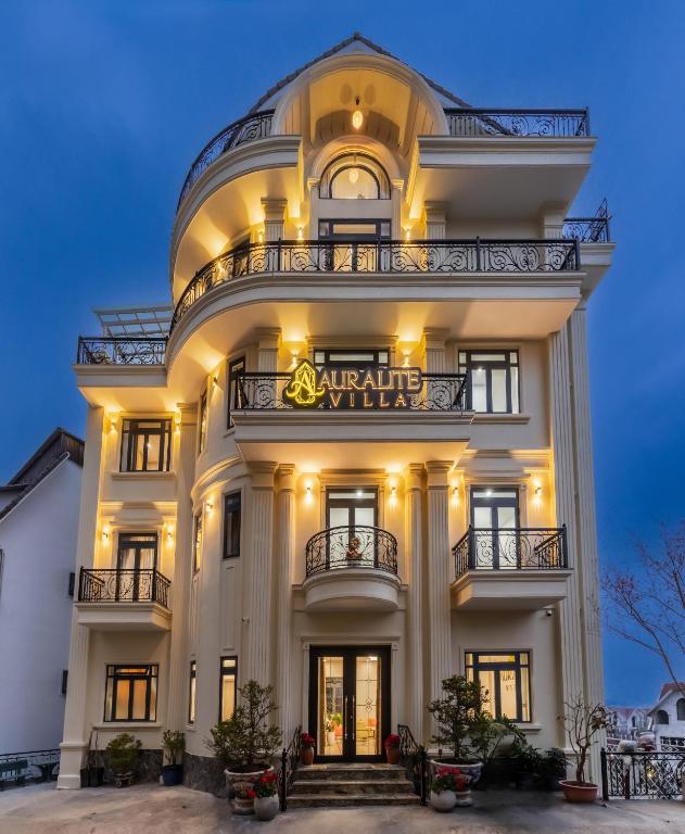 a large white building with a sign on it at AuraLite Hotel - Panorama View Đà Lạt in Da Lat