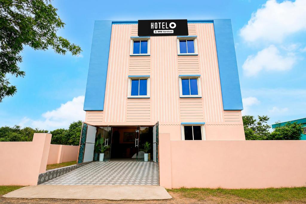 a pink building with a sign on it at Hotel O Bhubaneswar New Station Road in Bhubaneshwar