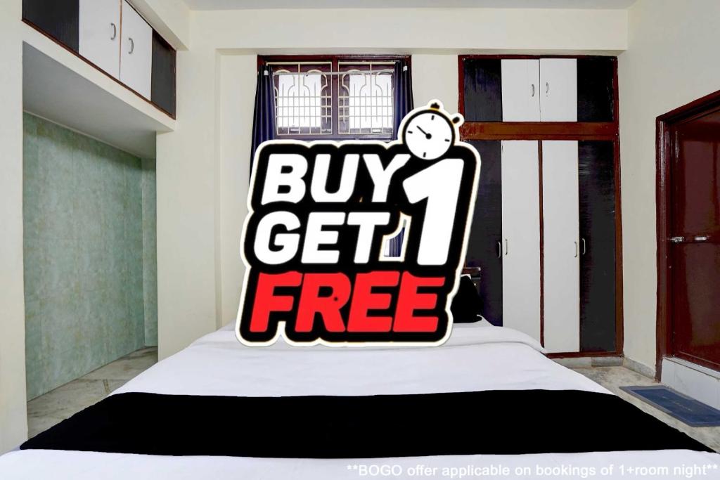 a bed with a buy get free sign on it at Hotel O Patel Nagar Patna Formerly Princess Home in Patna