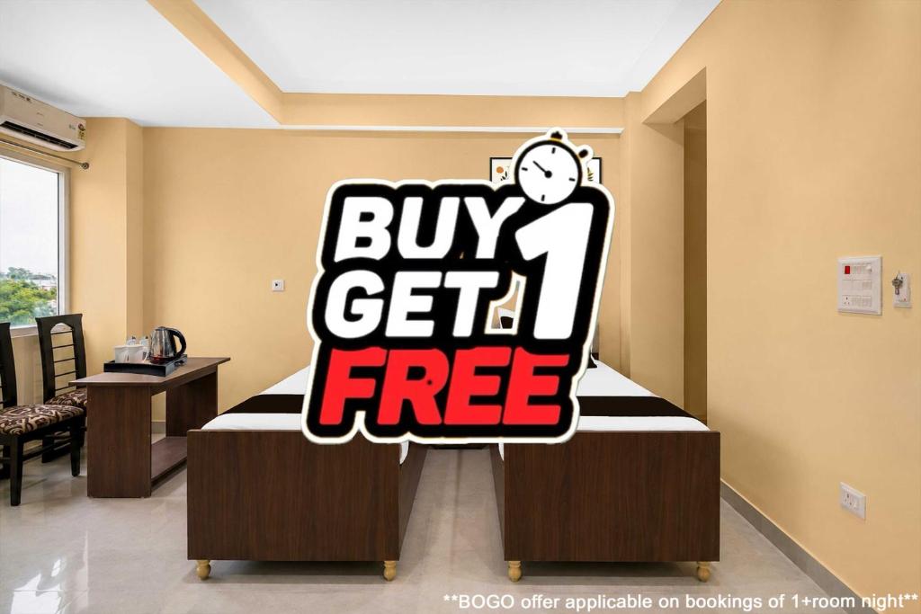 a buy get free sign on a bed in a room at Townhouse Defence Colony Noida in Greater Noida