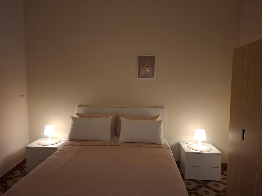 a bedroom with a bed with two lamps on it at B&B Campisi Anna in Altamura