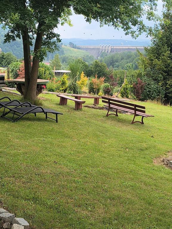 a group of park benches sitting in a field at Dom Wschodzącego Słońca in Solina