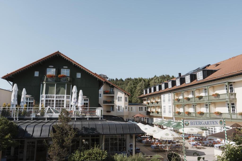 a group of buildings in a town with tables at Hotel Bayerischer Hof Miesbach, BW Premier Collection in Miesbach