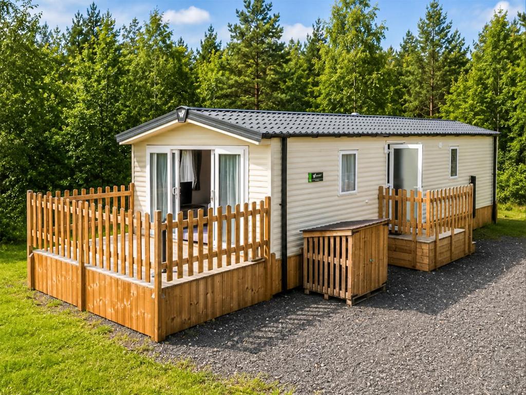 a tiny house with a fence and a gate at Astra - Ukc9718 in Aston