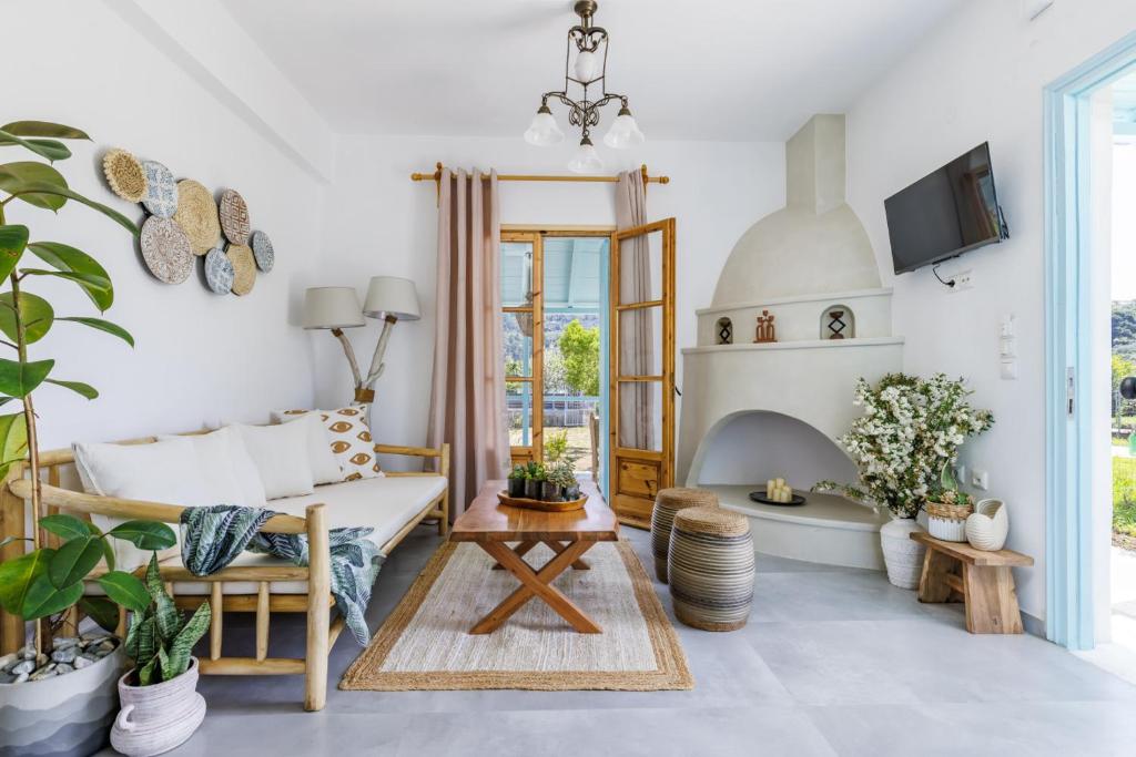 a living room with a couch and a fireplace at Amaranthos Garden Retreat in Skopelos Town
