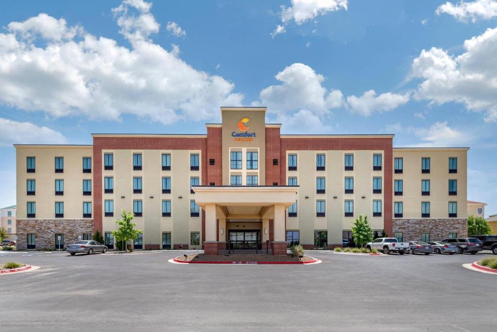 a large building with a parking lot in front of it at Comfort Suites Midland West in Midland