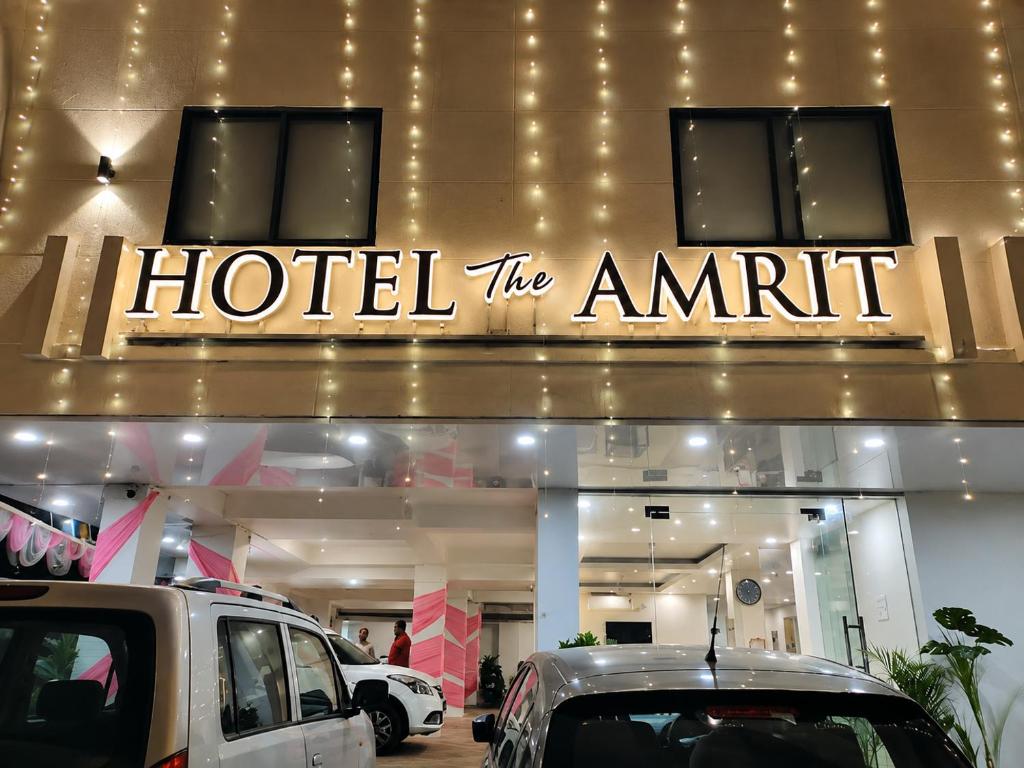 a hotel the ammt sign in front of a car dealership at Hotel The Amrit in Jabalpur