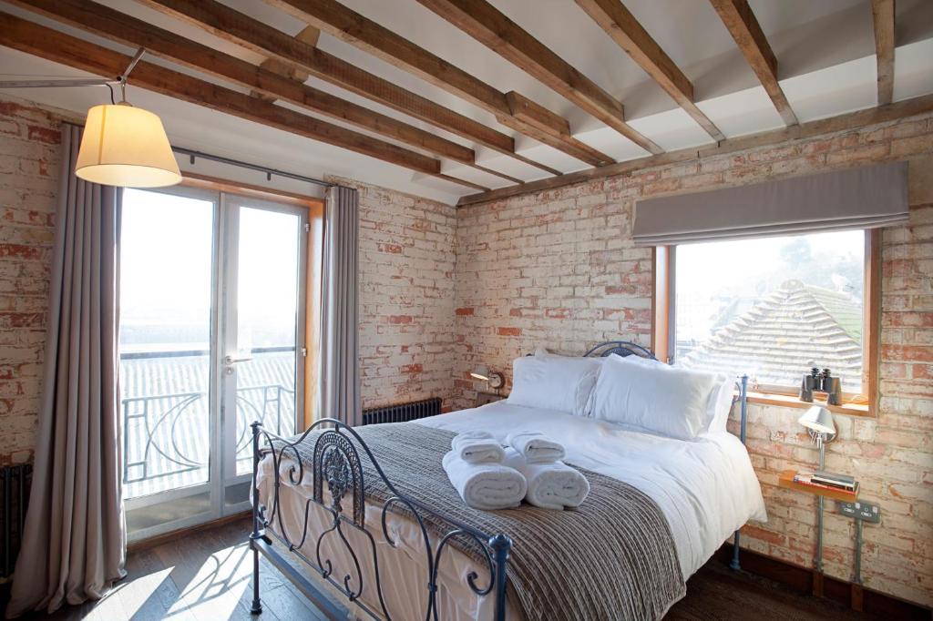 a bedroom with a bed with a large window at Rocksalt Rooms in Folkestone