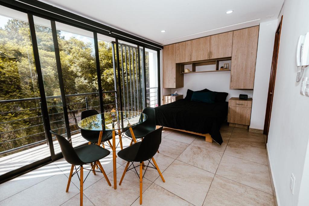 a living room with a glass table and chairs at Loft Reforma in Oaxaca City