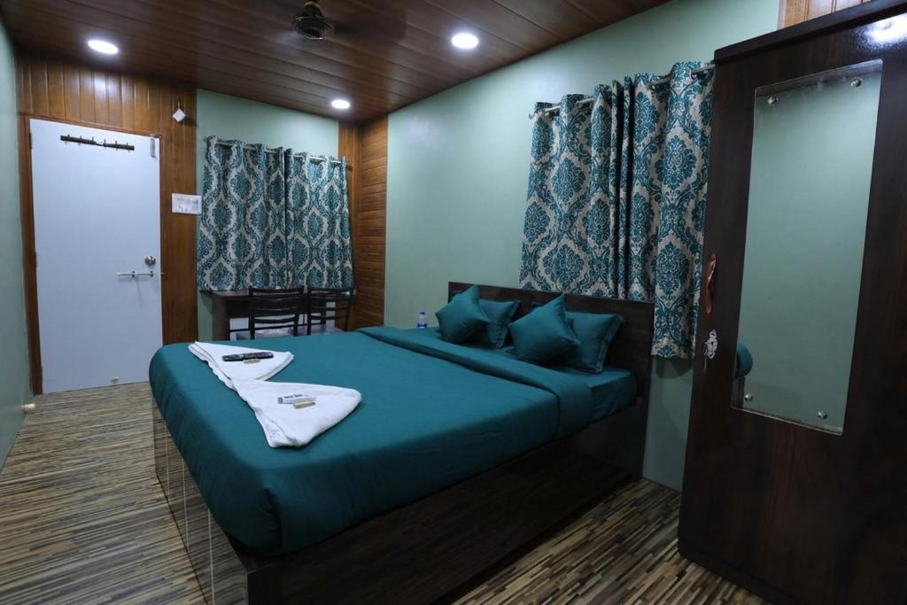 a bedroom with a blue bed in a room at FabHotels Rovio in Visakhapatnam