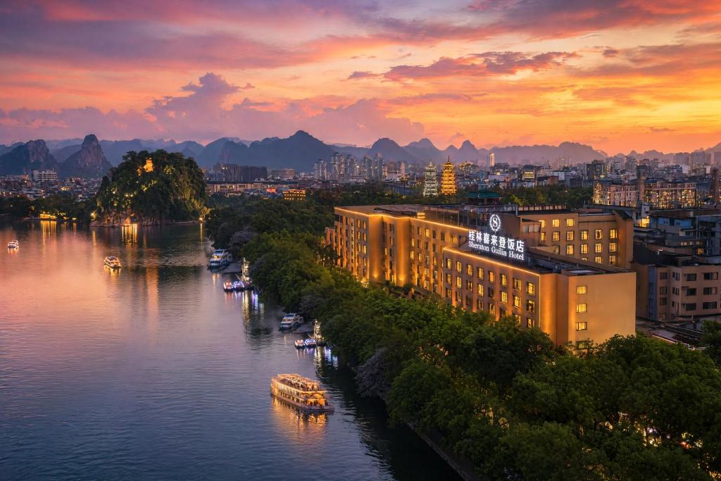 a view of a river with boats in a city at Sheraton Guilin Hotel in Guilin