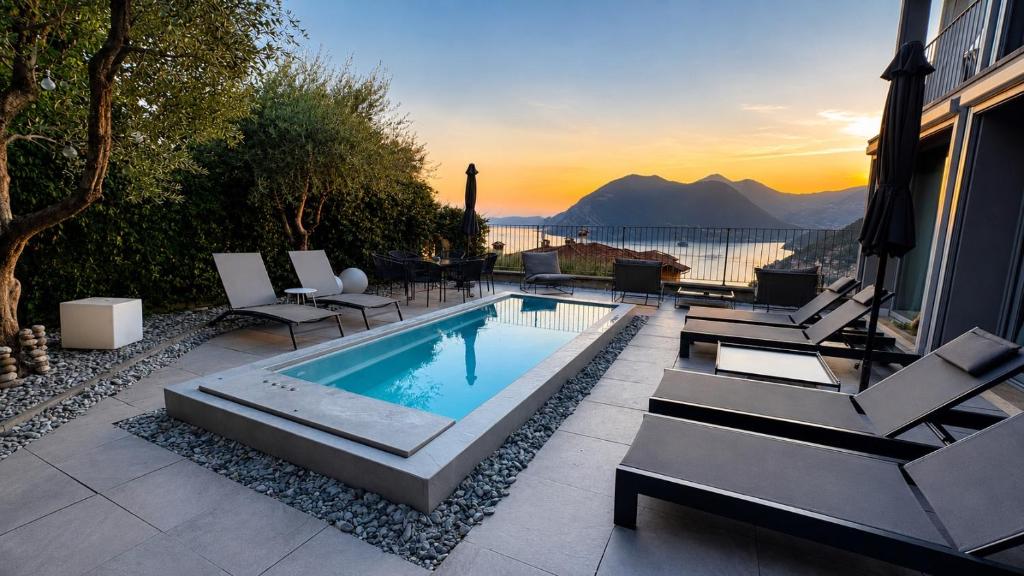a swimming pool with chairs and a view of the water at Villa Paolina in Sulzano