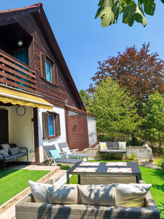 a patio with couches and chairs in front of a house at Buda Weekend House in Budapest