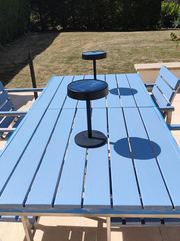 a blue picnic table with two stools on it at La Cabane du Noyer in Morée