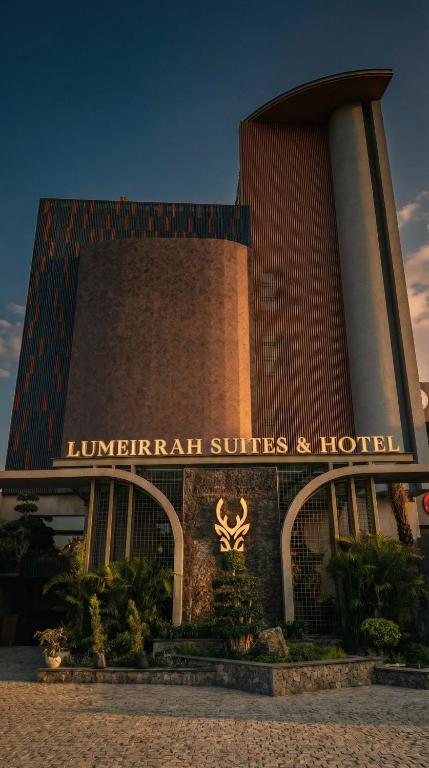 a hotel with a sign on the front of it at Lumeirrah Suites in Moga