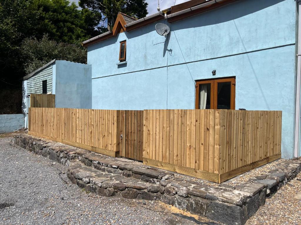 a wooden fence in front of a house at Tor Cefn in Kidwelly
