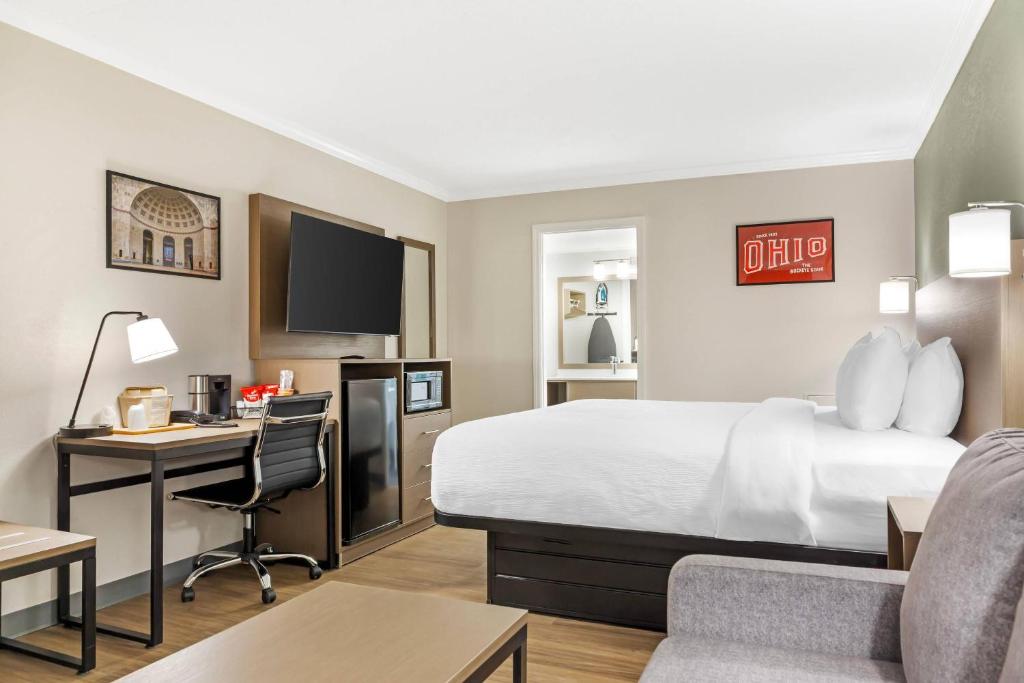 a hotel room with a bed and a desk at Quality Inn Findlay in Findlay