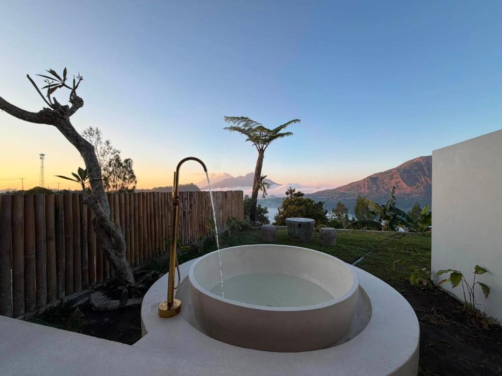 a bath tub with a view of the mountains at Pinggan Plato in Baturaja