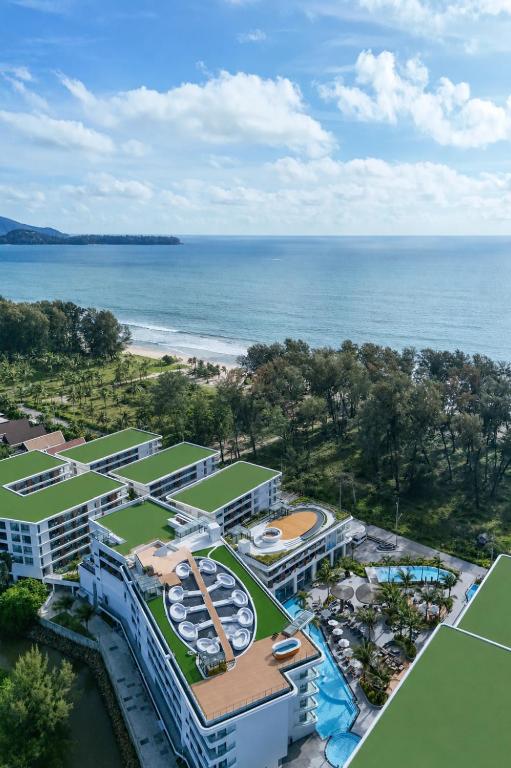 an aerial view of a resort with a tennis court at Kora Beach Resort Phuket in Bang Tao Beach