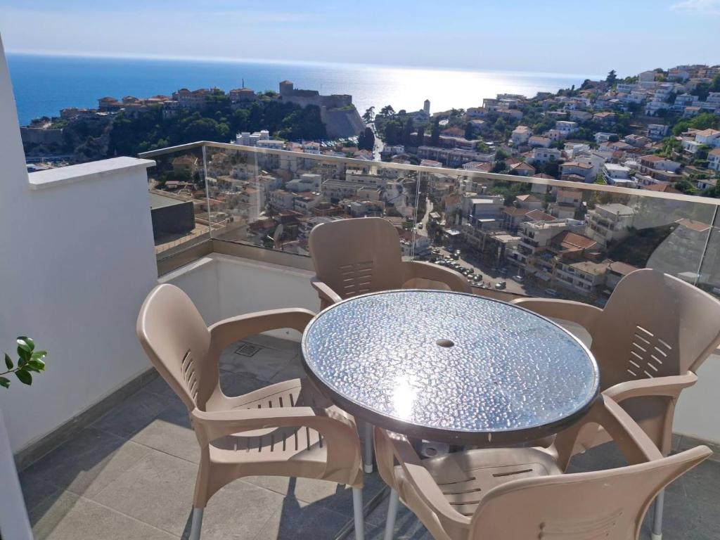 a table and chairs on a balcony with a view at Apartments Radoman in Ulcinj