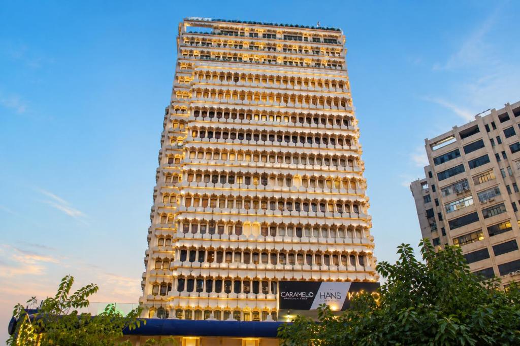 a tall building with a lot of windows at Hotel The Hans - Connaught Place, New Delhi in New Delhi