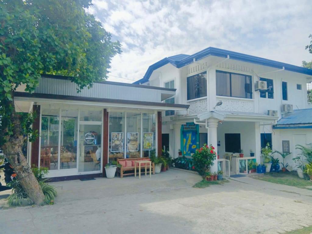 a white house with a blue roof at New Modern Summer House in Moalboal