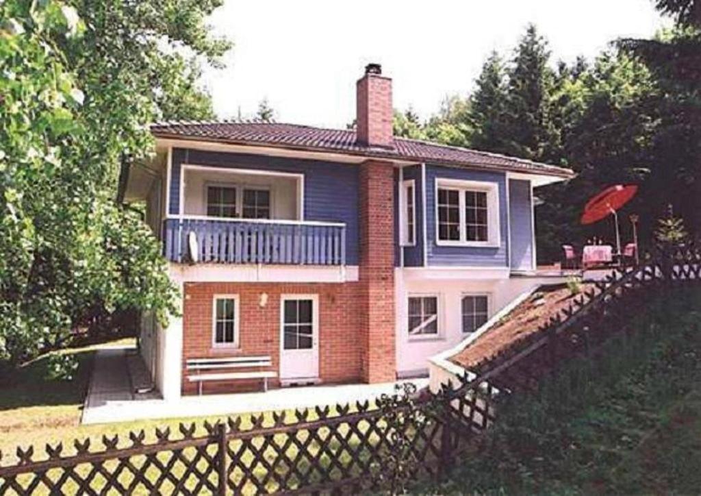a house with a fence in front of it at Ferienwohnung Am oberen Hexenstieg in Altenbrak
