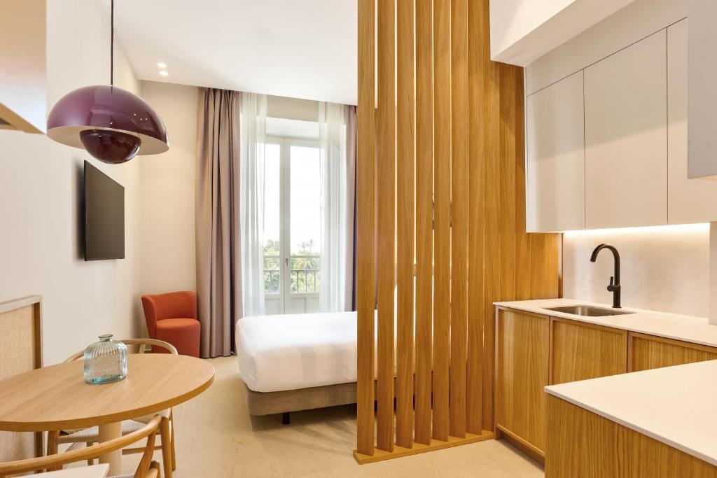 a kitchen with a bed and a table at Ocean Drive Málaga - New Opening 2026 in Málaga