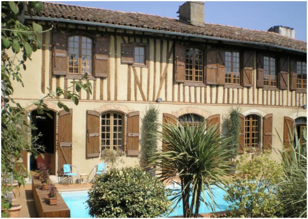 a large house with a pool in front of it at Guest House, Private Pool in LʼIsle-en-Dodon