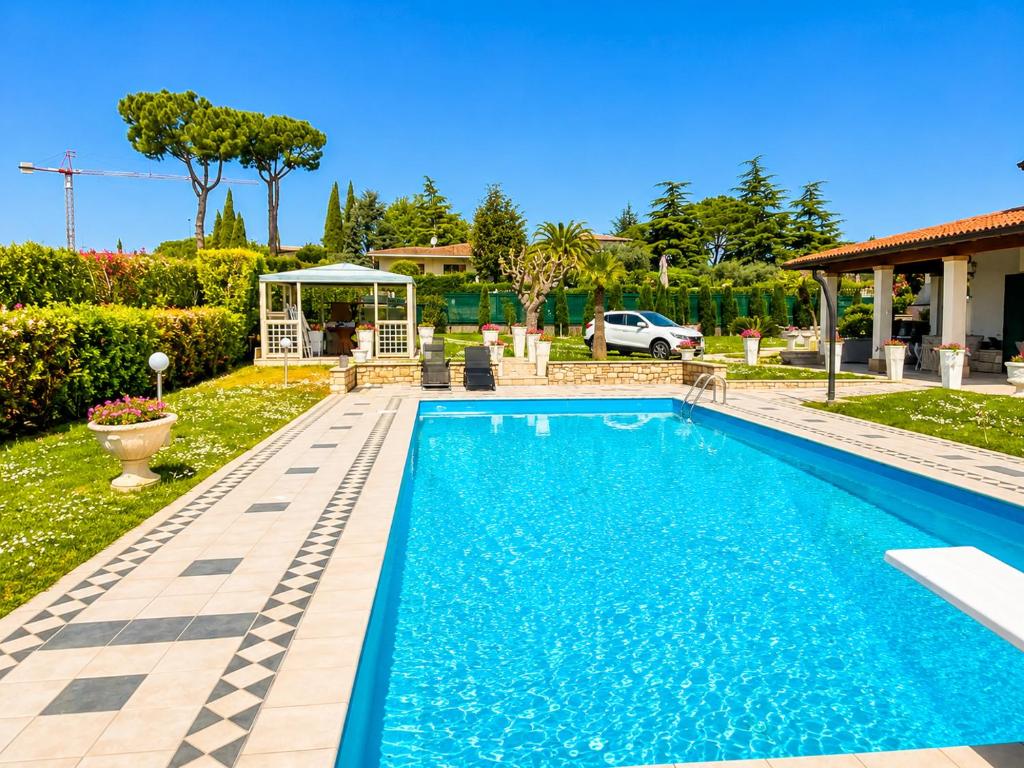 a swimming pool in the backyard of a house at La Dolce Vita - Private Villa with Pool in Moniga