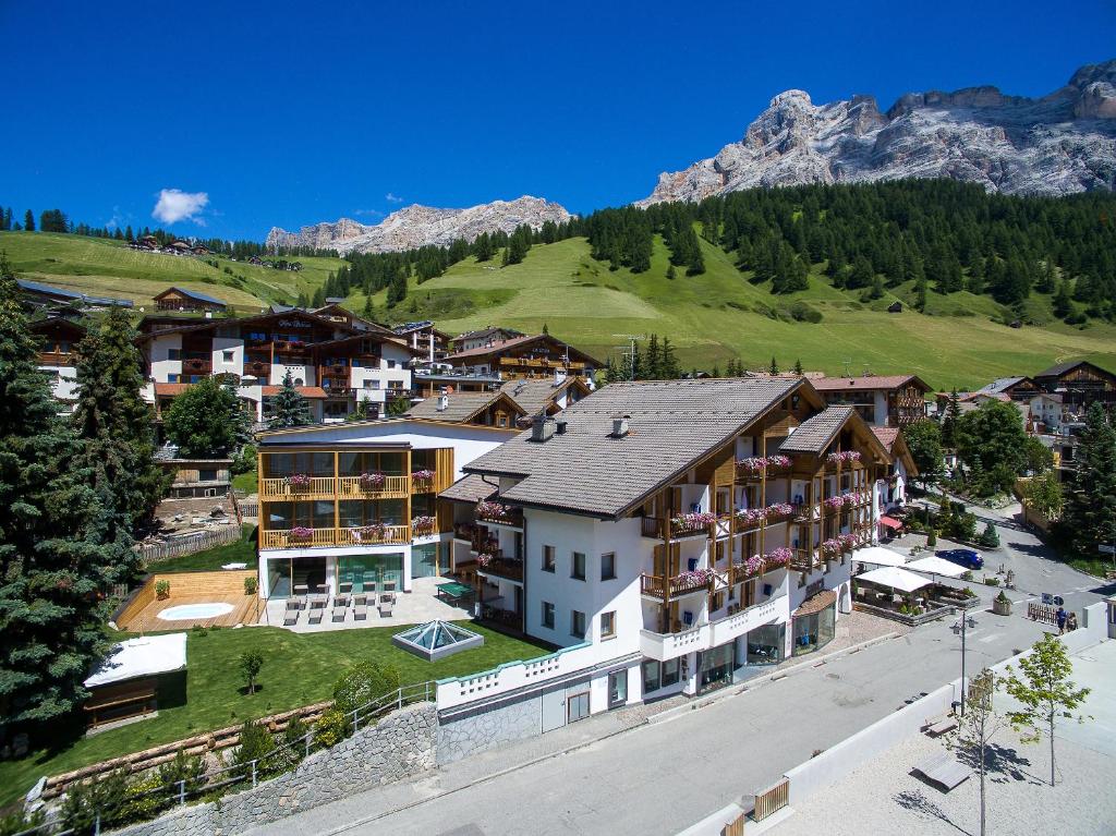 an aerial view of a town with a mountain at Hotel Vajolet in San Cassiano