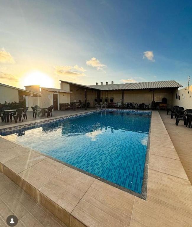 a large swimming pool in front of a building at Chalés Estrelas Do Mar in Barra Nova