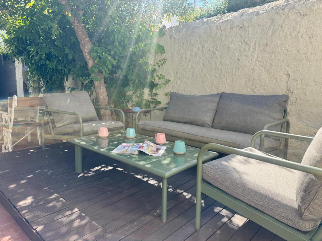 a patio with a couch and a table and chairs at Villa Monturiol in Llafranc