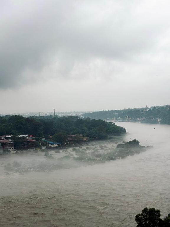 an island in the middle of a river at Om Guesthouse in Rishīkesh