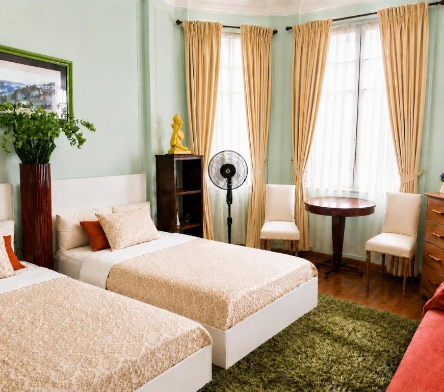 a bedroom with two beds and a desk with a fan at Home for 2 few steps from center of Monte Carlo in Beausoleil