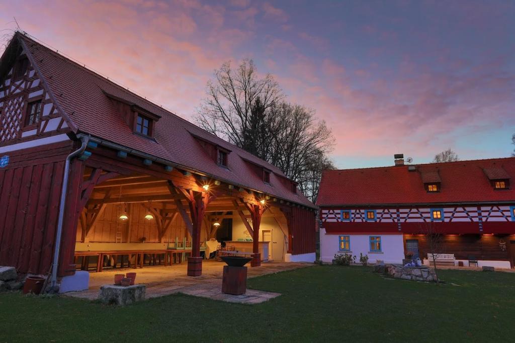 a large barn with a sunset in the background at Statek Salajna in Salajna