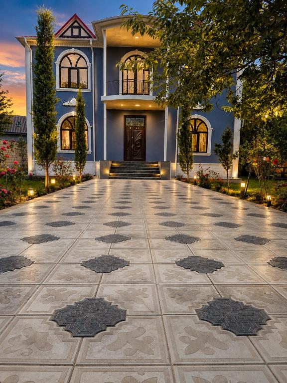 a house with a driveway in front of a building at Hillside villa in Gabala
