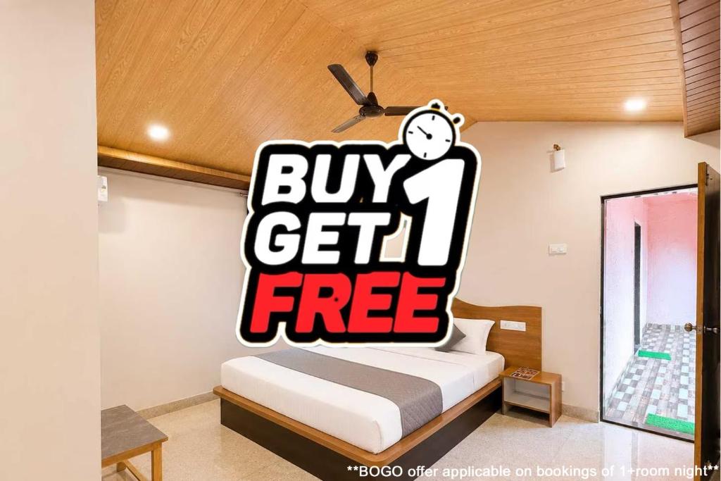 a bedroom with a buy get free sign on the wall at Collection O Parsi Point Mahabaleshwar Formerly Jungle Eye in Mahabaleshwar