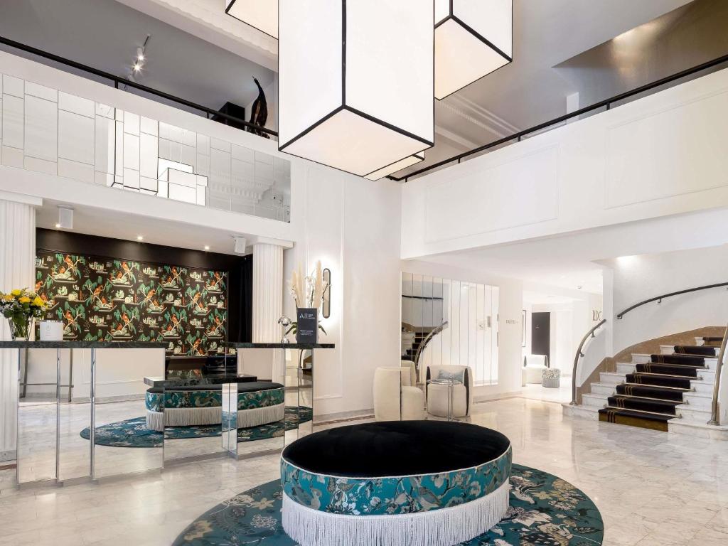 a lobby with a large circle in the middle of a room at The 1932 Hotel & Spa Cap d'Antibes - MGallery Collection in Juan-les-Pins