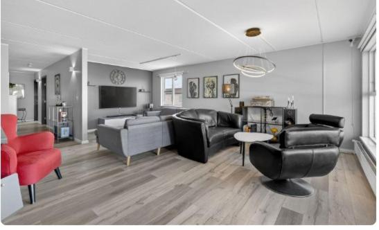 a living room with couches chairs and a television at Large apartment in Reykjanes in Ytri-Njarðvík