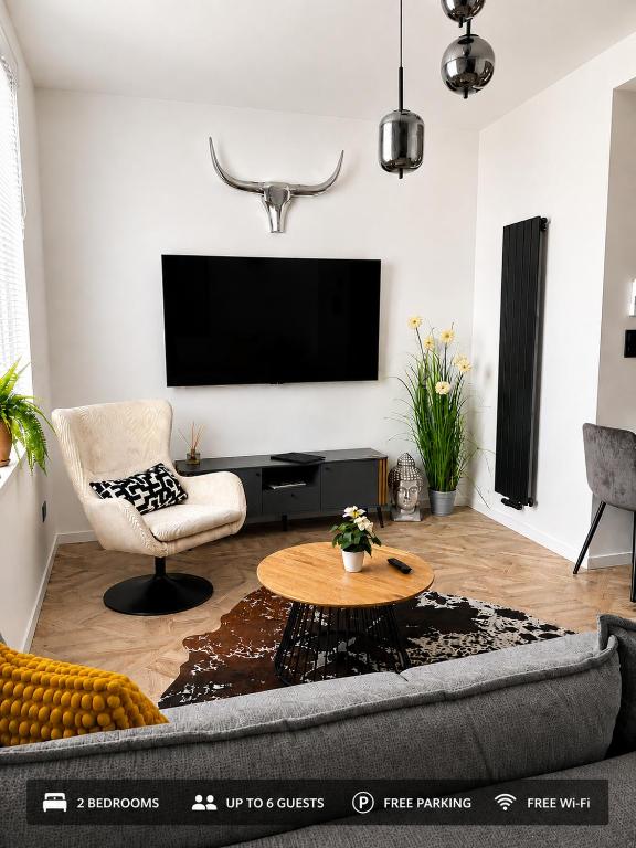 a living room with a couch and a tv at LUX 3 bedroom apartman in Trenčín