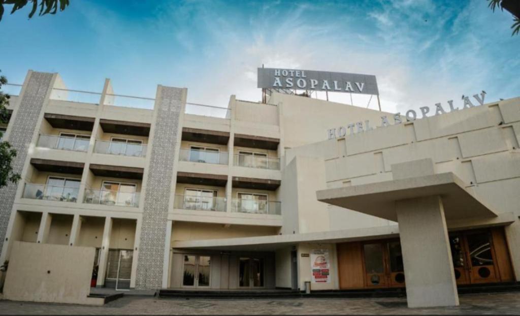 a building with a sign on top of it at Hotel Asopalav in Junagadh