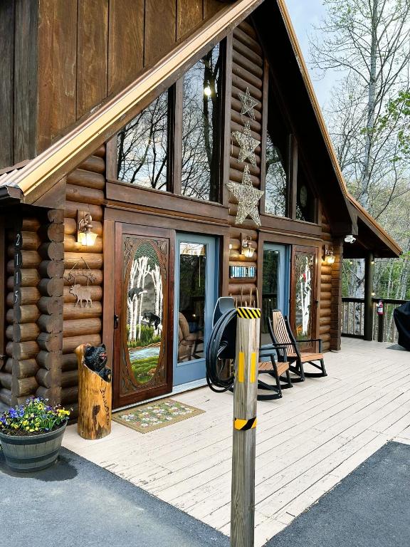 a log cabin with a porch and a deck at Wonderland Cabin in Sevierville