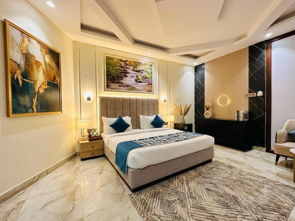 a bedroom with a large bed in a room at Hotel De - Grand Villa Near Delhi IGI Airport in New Delhi