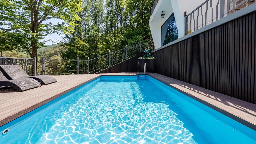 a swimming pool in the backyard of a house at Wonju Healing Forest in Wonju