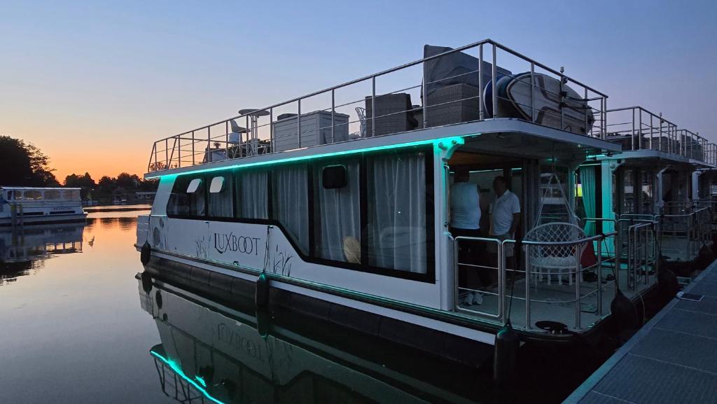 a ferry boat is docked on the water at Hafensuite In Templin Uckermark in Templin