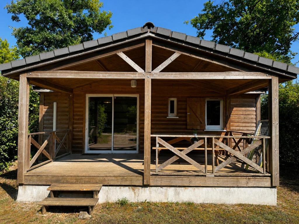 a log cabin with a porch and a large door at Chalet Riviera in Autruy-sur-Juine